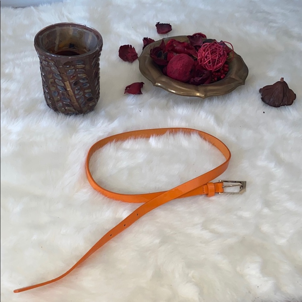 Orange belt with golden buckle